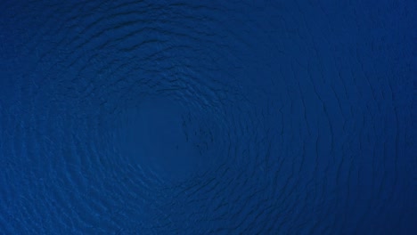 water circle spinning and spreading motion surface in blue shade.