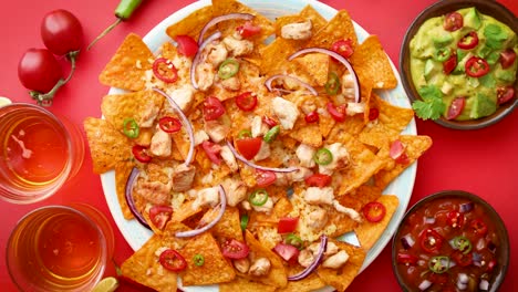 a plate of delicious tortilla nachos with melted cheese sauce  grilled chicken