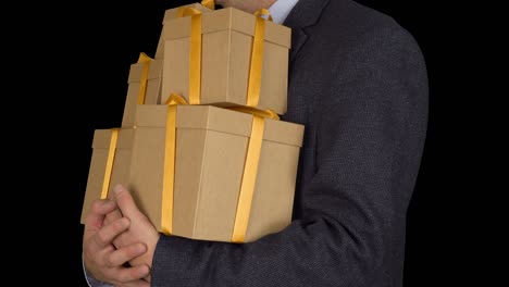 caucasian man in classic suit stand and hold many gift boxes. brown gift box. businessman present gifts on holiday eve. alpha channel chroma key transparent background. locked down.