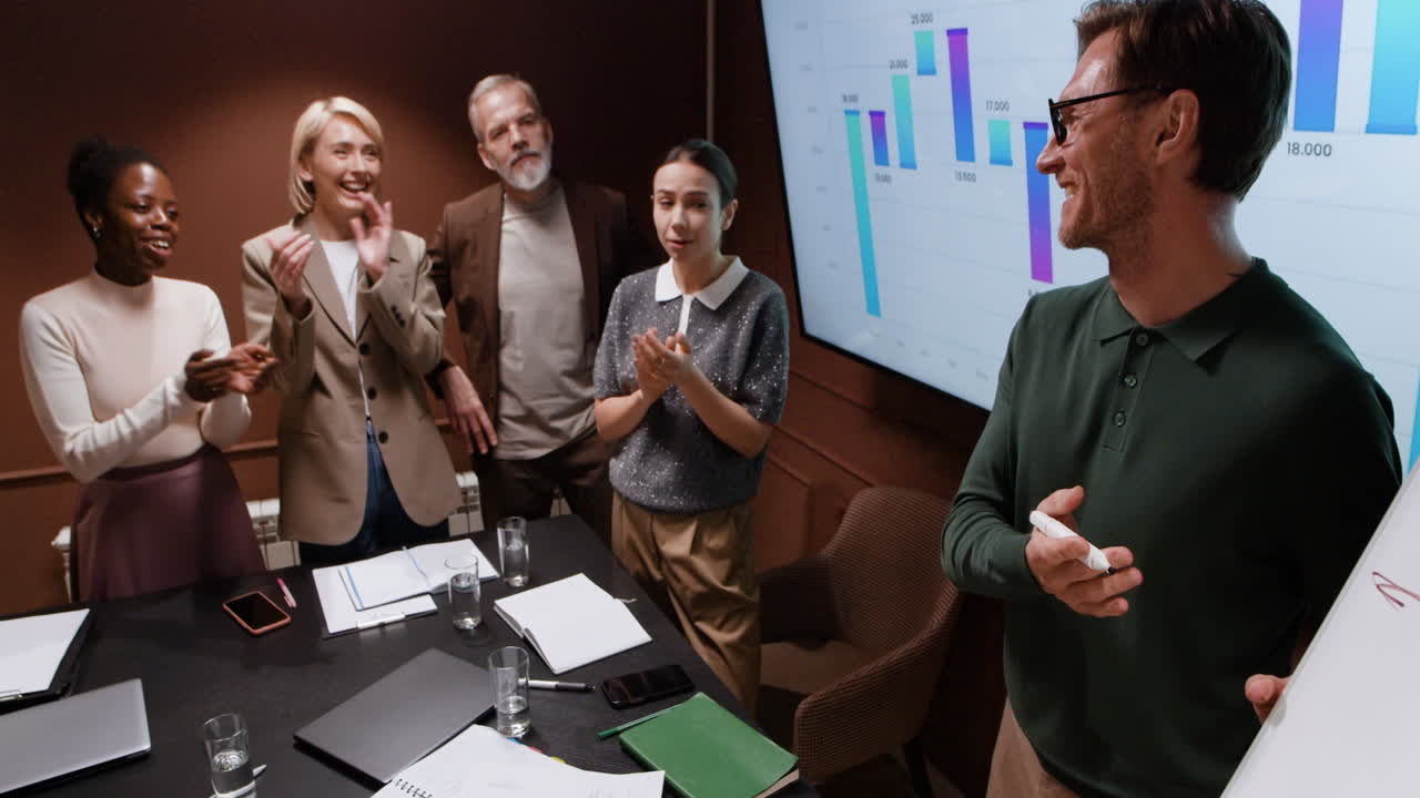 Business Team Applauding a Successful Presentation in a Conference Room