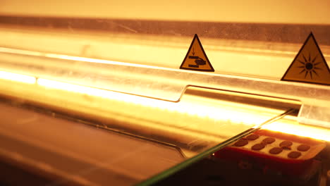 Automated-laminated-glass-cutting-machine-operating-illuminated-processing-thermal-sheet-layers