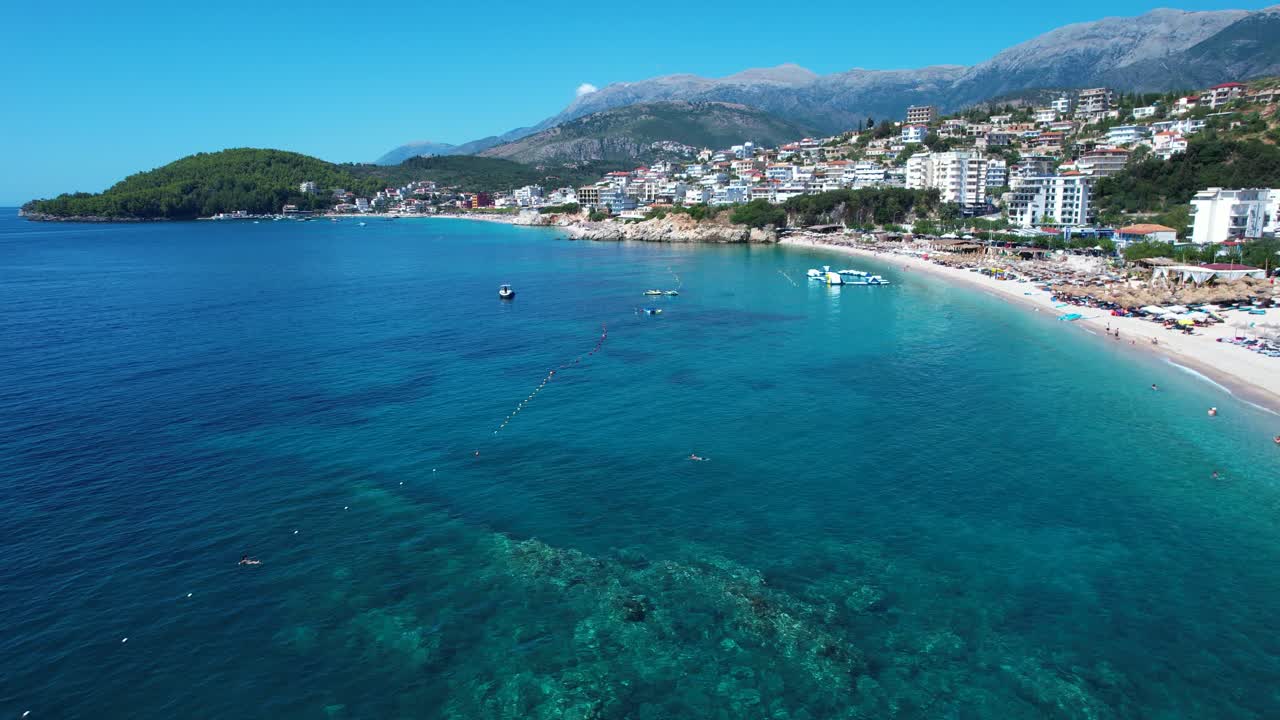 Tourists Enjoy Quiet Sunbathing at Himara Beach Resorts Facing the Sparkling Blue Ionian Sea
