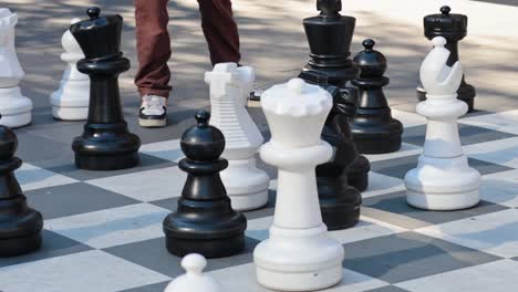 people playing giant chess in a public space