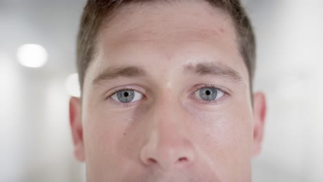 Unaltered-portrait-of-happy-caucasian-male-doctor-opening-eyes-and-looking-at-camera