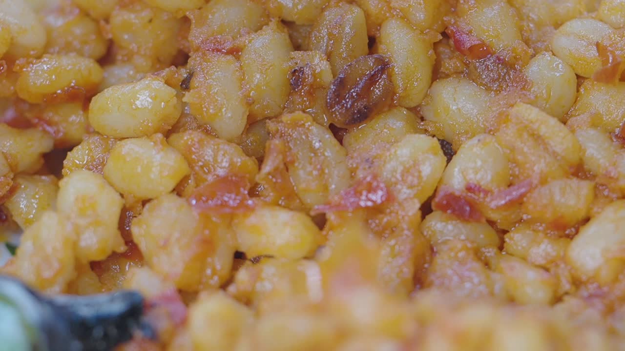 Close-up of a plate of cooked beans with sauce