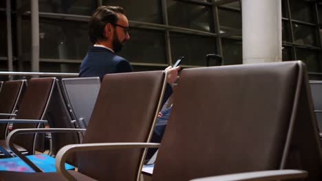 commuter using mobile phone in waiting area 4k