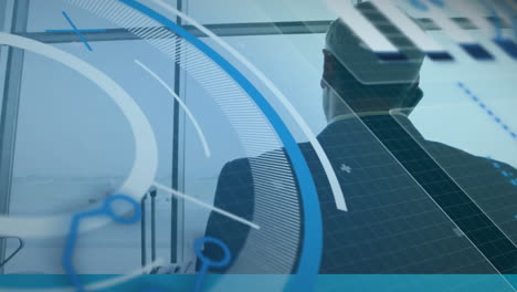 animation of interface with data processing over rear view of businessman at an airport