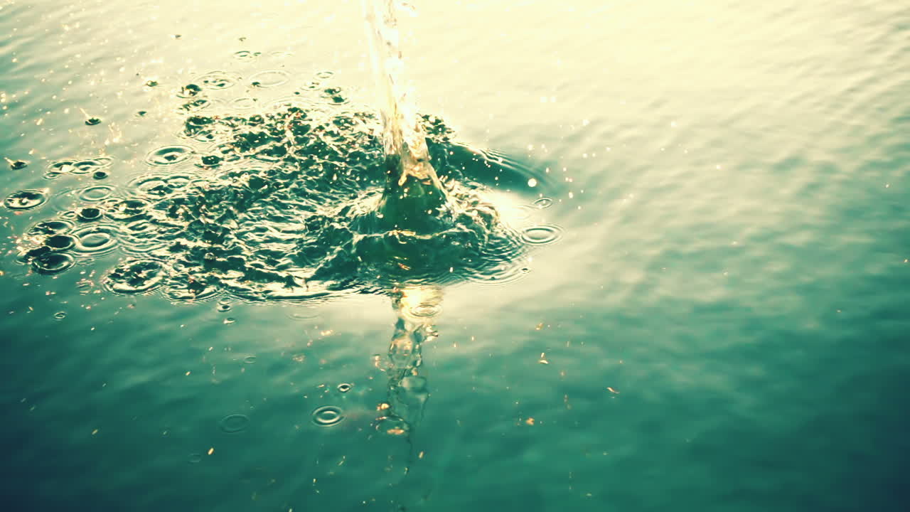 The stone falls in water. Slow Motion