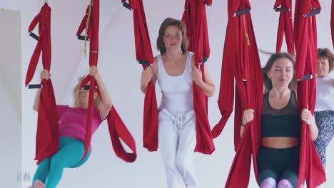 ladies restore energy swinging in hammocks after yoga class