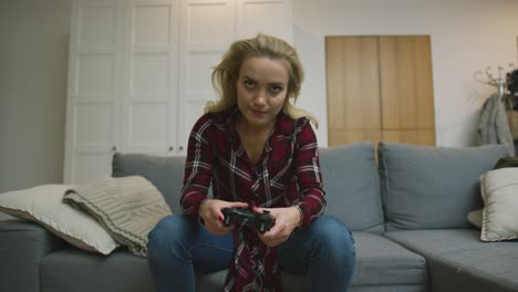 serious woman playing video game