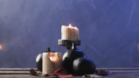 video of carved pumpkins, candles and smoke with copy space on purple background