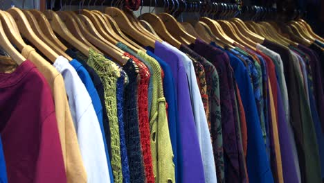 colorful shirts hanging on hangers in a clothing shop