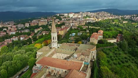 Aerial-of-the-town-of-Borgo-XX-Giugno-and-the-Abbazia-di-San-Pietro-Benedictine-abbey,-Perugia,-Province-of-Perugia,-Italy