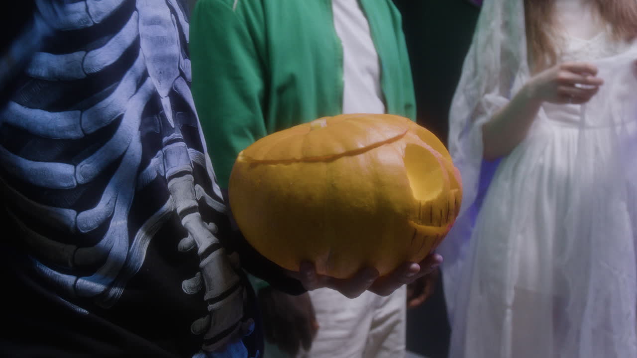 Halloween Costume Party with Carved Pumpkin