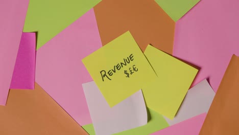 business concept of revolving sticky notes with revenue written on top note