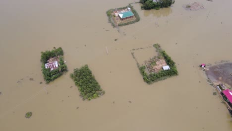 rural home village in flooded landscape in bangladesh, south asia. aerial drone shot