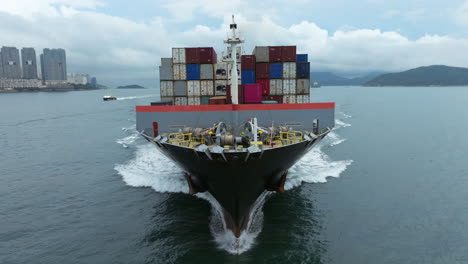 descent todwards the bow of a large container ship - close up approaching shot