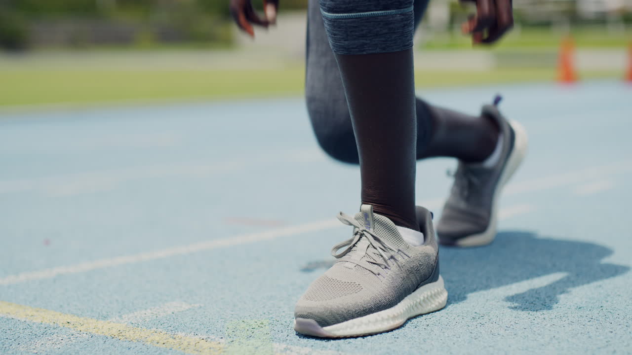Closeup of an African female athlete tying shoe