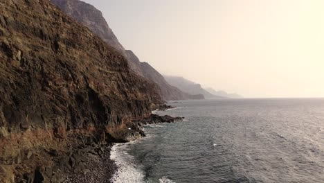 Idyllic-scene-of-two-people-at-unspoiled-virgin-beach-in-Gran-Canaria,-Spain-during-summer-time-on-vacations