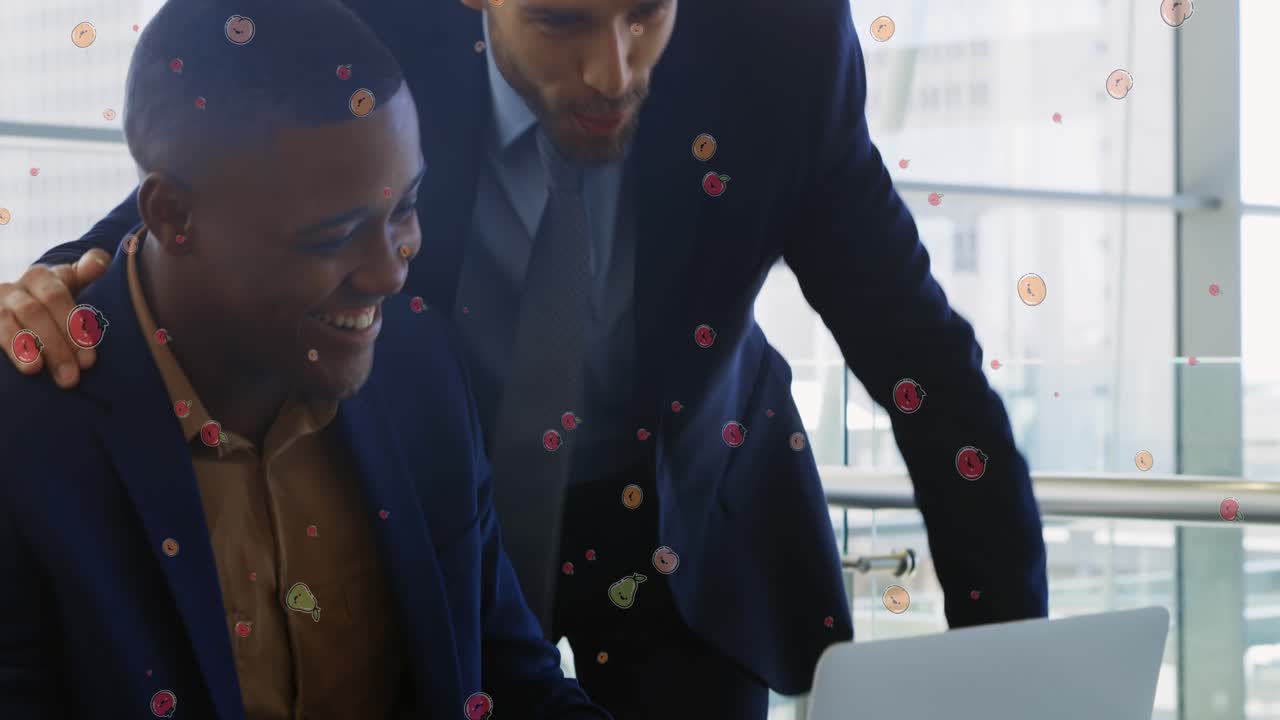 Animation of fruit icons over diverse businessmen talking