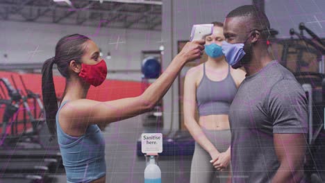 animation of moving lines over diverse people wearing face masks and exercising at gym