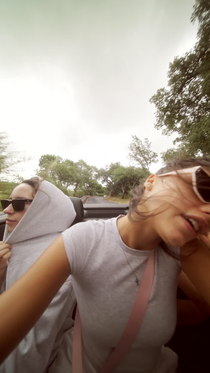 Women enjoying a road trip in a convertible