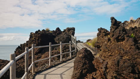 viewpoint, camera moving forward unveiling the rocky high cliffs of the coastline in the azores island, portugal