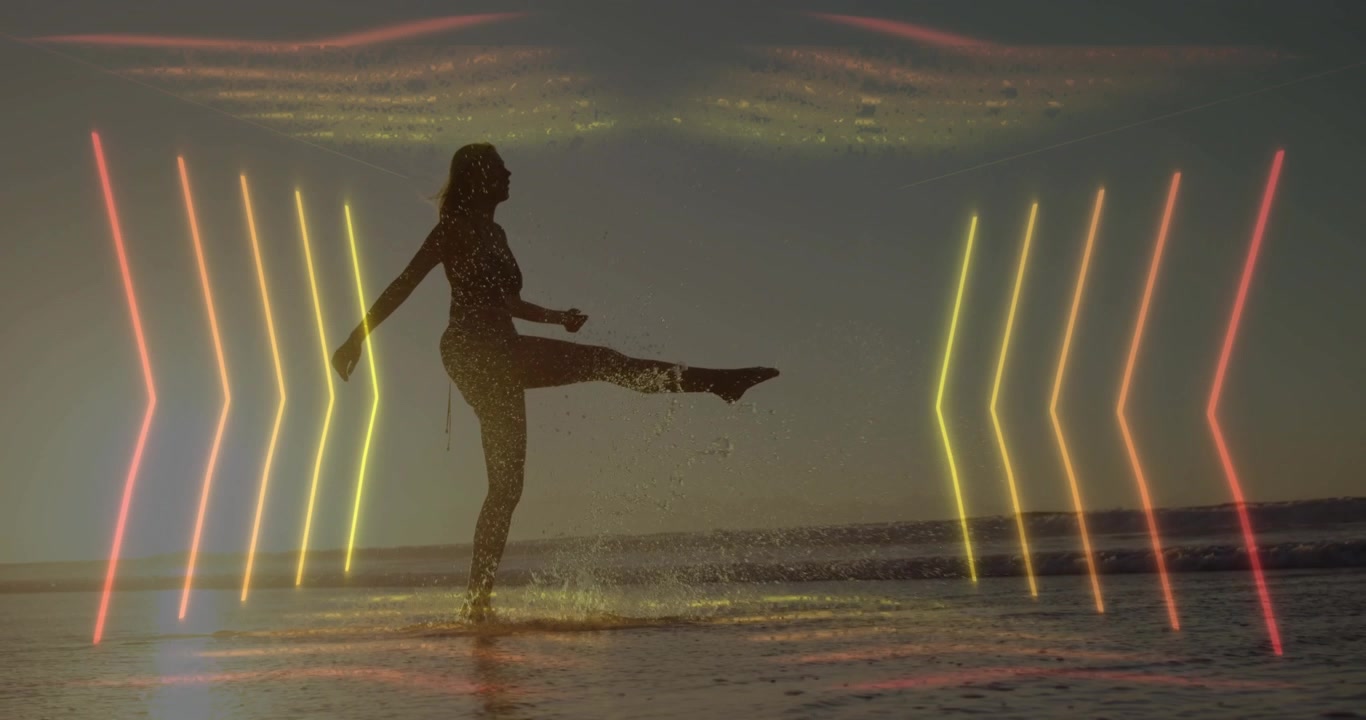 Vertical video: Walking bikini woman on sunset beach, neon chevrons pulsing, kicking to catch sun