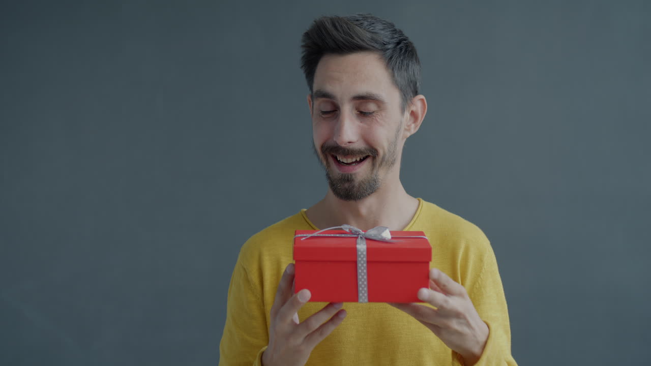 Man Excitedly Holding a Gift Box
