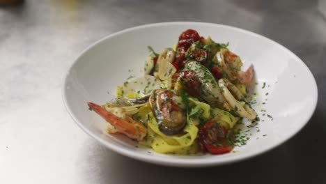 Olive-oil-on-top-of-spaghetti-tagliatelle-with-seafood-Mediterranean-traditional-food-professional-gourmet-chef-restaurant-kitchen