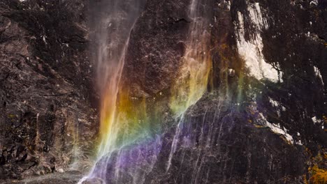 Rainbow-shining-upon-a-waterfall,-providing-a-stunning-view