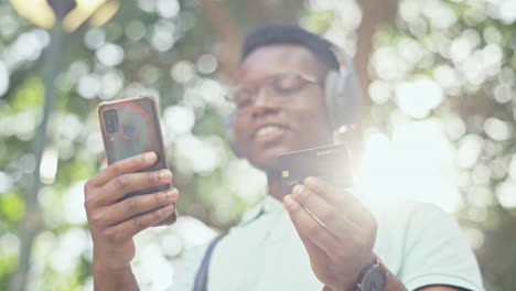 Finance,-phone-or-black-man-in-park-with-credit