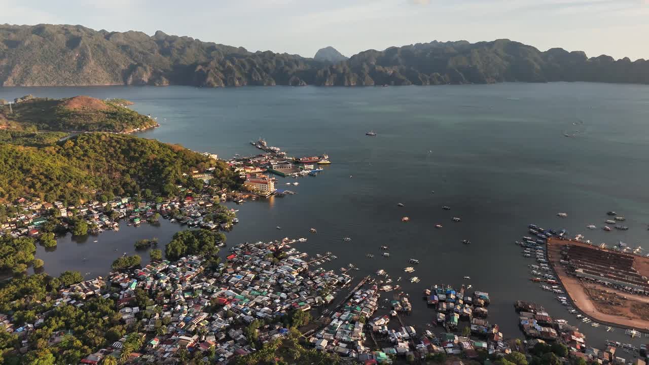 A drone view over Coron Town, in Palawan Island with colorful boats and housing in the water in the Philippines