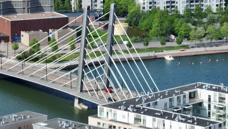 Telephoto-drone-shot-around-the-Cruselli-bridge,-summer-in-Ruoholahti,-Helsinki