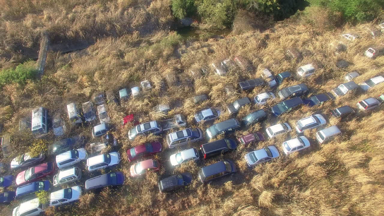Haunting aerial footage reveals hundreds of abandoned vehicles slowly being reclaimed by nature in Fukushima's exclusion zone