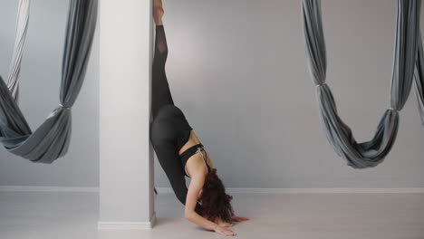 woman performing yoga stretches and aerial yoga poses