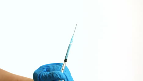 doctor showing syringe to camera