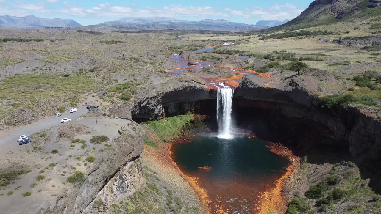 Acid waterfall in the middle of nature with tourists around in argentina