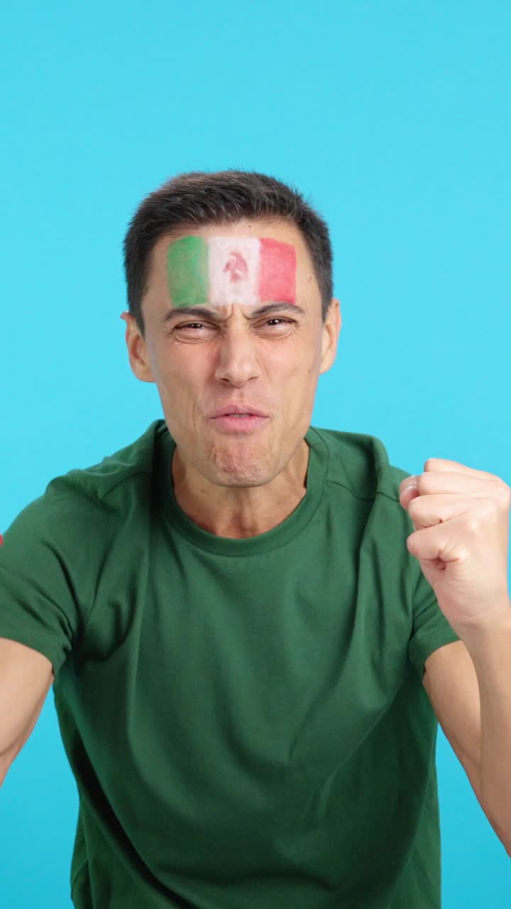 Man cheering for Mexico screaming and waving a national flag