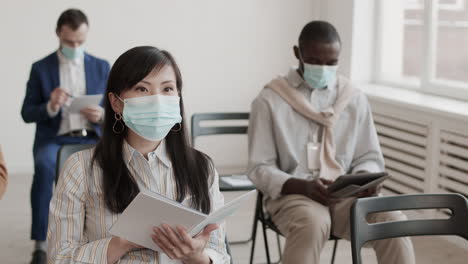 Asian Businesswoman in Mask Reading