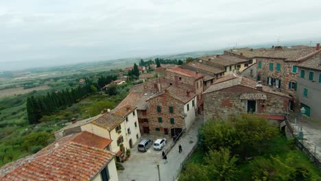 drone fly over medieval town houses of lucignano, arezzo, tuscany italy