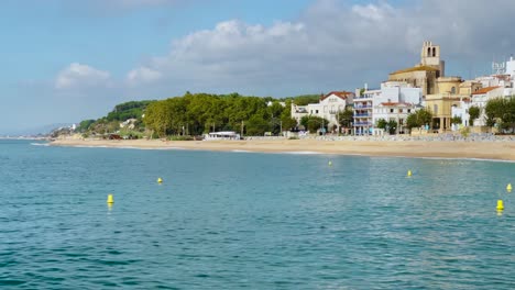 Platja-de-les-Barques-sea-field-Maresme-Barcelona-Mediterranean-coast-plane-close-to-turquoise-blue-transparent-water-beach-without-people