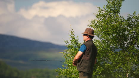 A-fisherman-casting-his-fishing-line-among-the-mountains-of-Norway