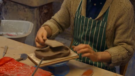 Potter-flattening-a-clay