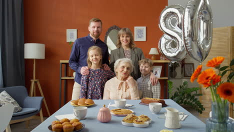 portrait of happy family at grandma birthday dinner