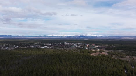 Wide-angle-drone-shot-of-West-Yellowstone-and-the-pine-forest-that-surrounds