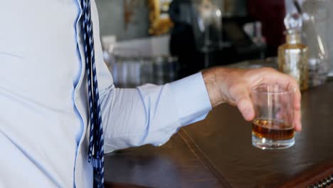 Businessman-having-a-glass-of-whisky