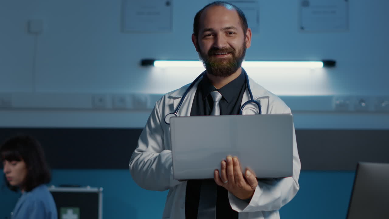Doctor holding a laptop in a hospital setting