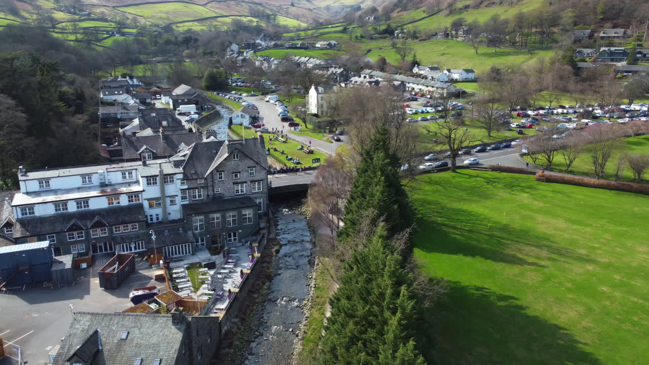 LAKE DISTRICT, UNITED KINGDOM - MAY 05 2023: Aerial drone view of village and river