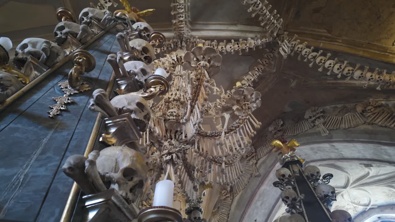 Ornate bone chandelier at Sedlec Ossuary in Kutná Hora, Czech Republic, creating a haunting ambiance